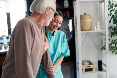 Woman helping man walk