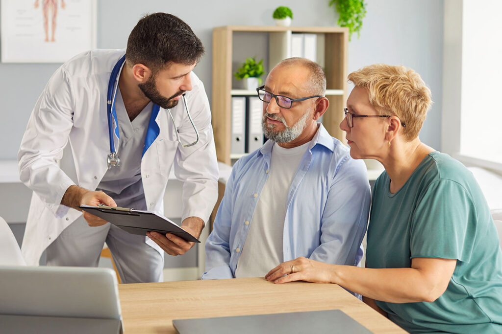 Family sitting around a table discussing senior care options together